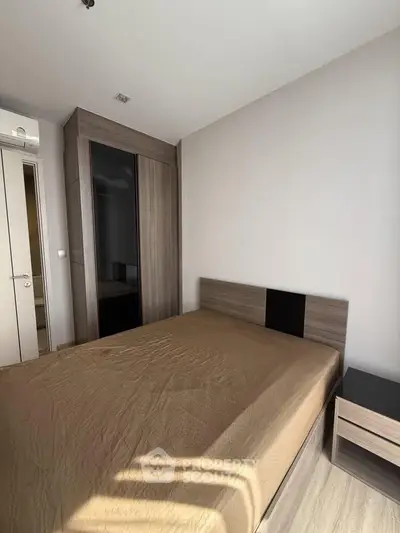 Modern bedroom with sleek wardrobe and natural light, perfect for urban living.