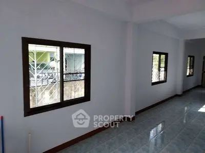 Spacious interior with large windows and tiled flooring, perfect for customization.