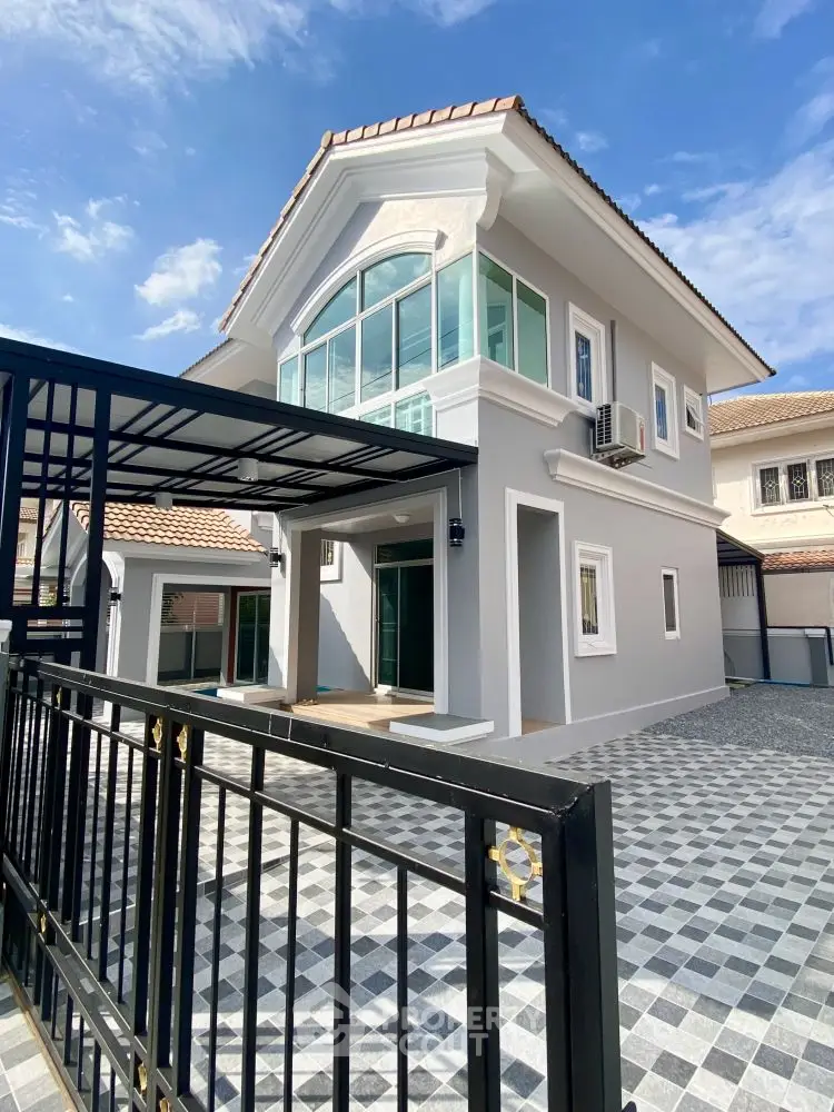 Stunning modern two-story house with elegant facade and spacious driveway.
