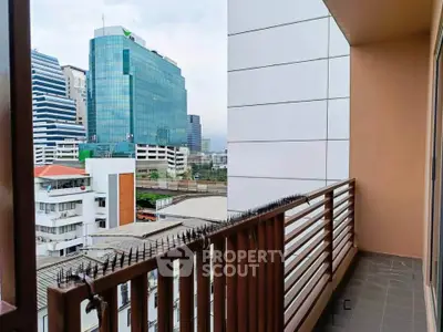 Modern balcony with city view in high-rise building, perfect for urban living.