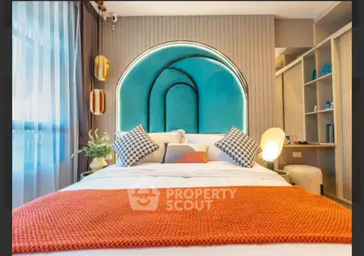 Stylish modern bedroom with vibrant decor and unique headboard design.