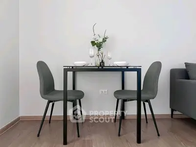 Modern minimalist dining area with sleek table and chairs, perfect for cozy meals.