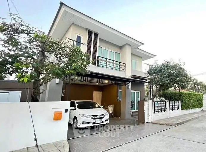 Modern two-story house with carport and landscaped front yard in a serene neighborhood.
