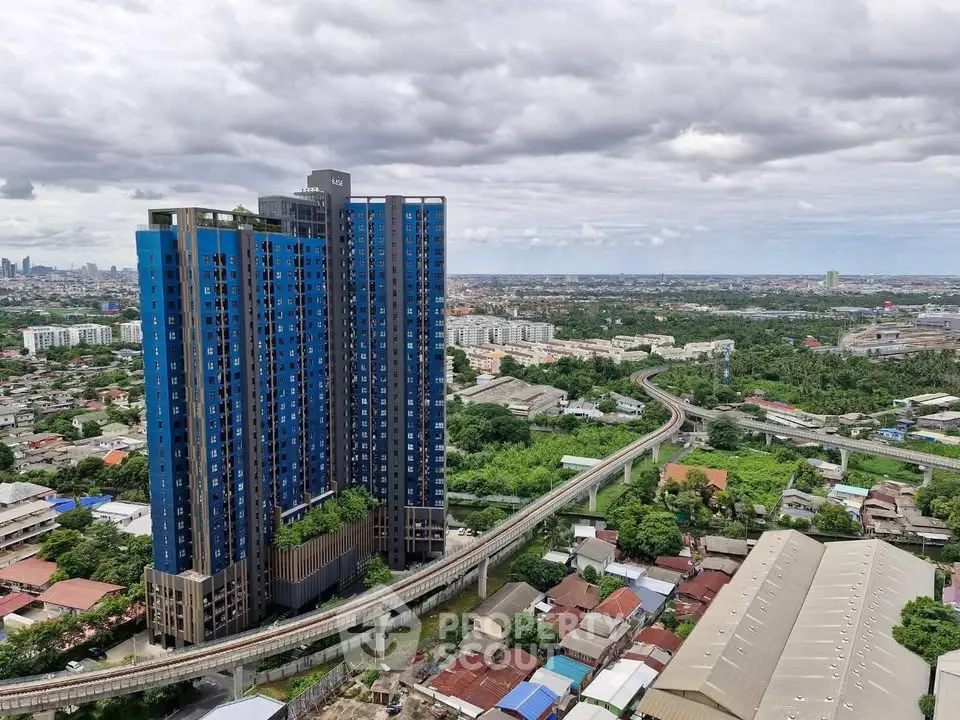 Stunning high-rise building with panoramic city views and lush surroundings.