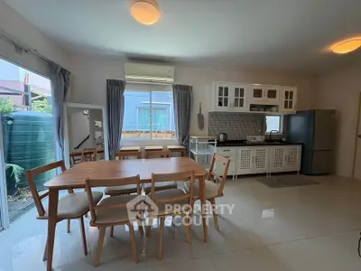 Spacious open-layout kitchen and dining area with modern appliances and natural light.