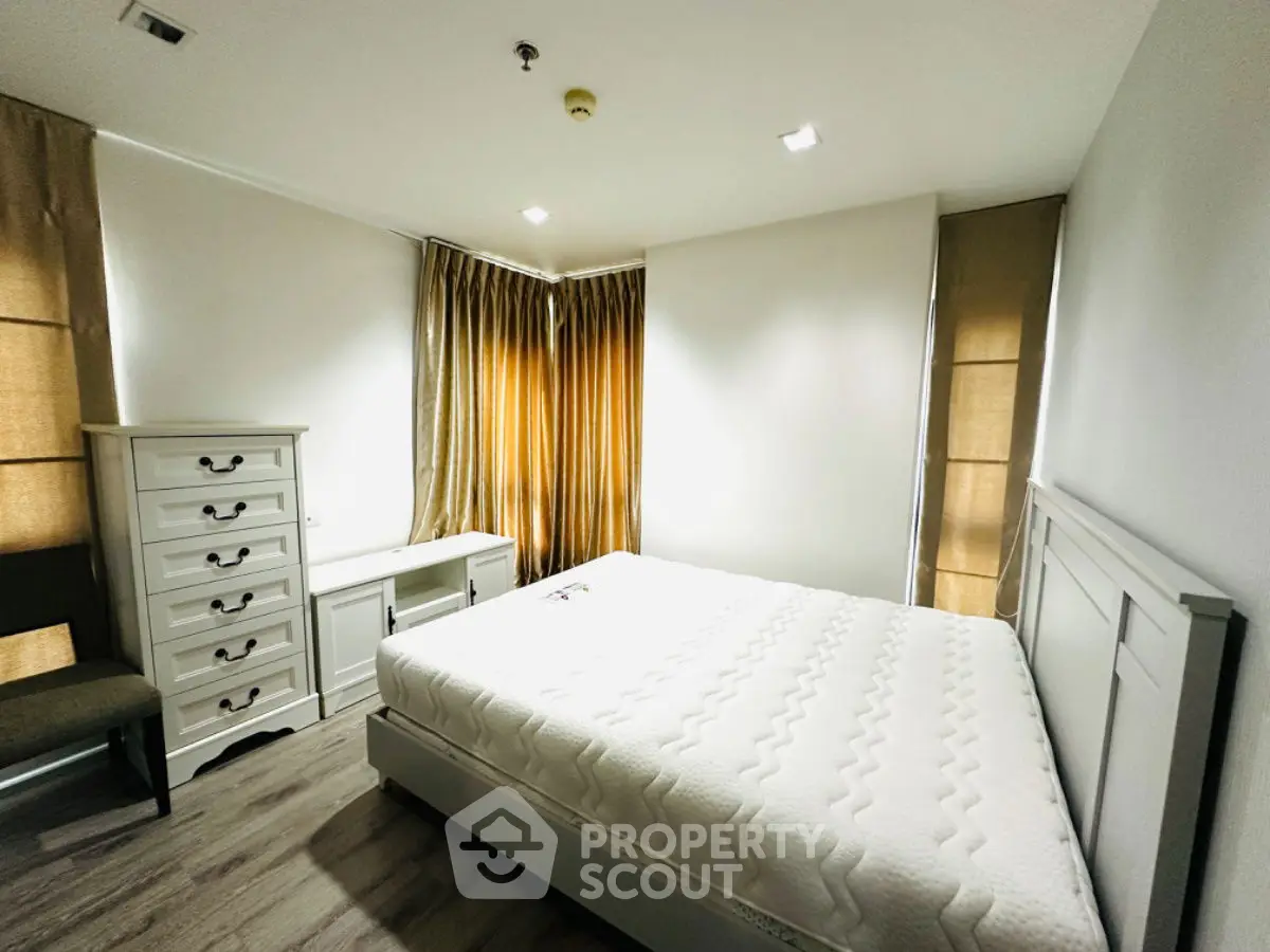 Spacious bedroom with modern furniture and natural light