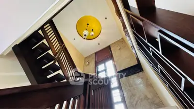 Elegant staircase with modern design and stylish lighting in a luxurious home interior.