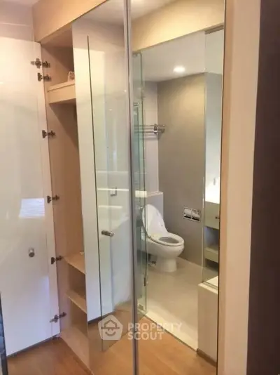 Modern bathroom with glass partitions and sleek fixtures