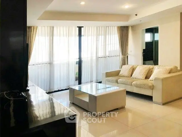 Spacious living room with modern decor and large windows for natural light.
