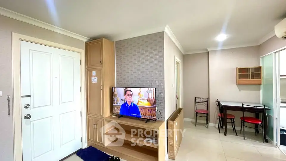 Cozy living room with modern decor and TV, perfect for relaxation.
