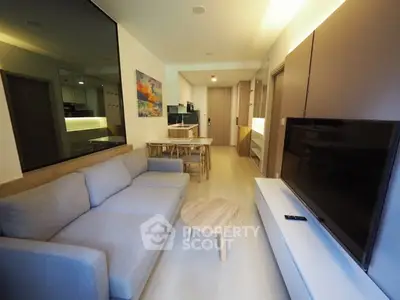 Modern living room with cozy sofa and large TV in stylish apartment