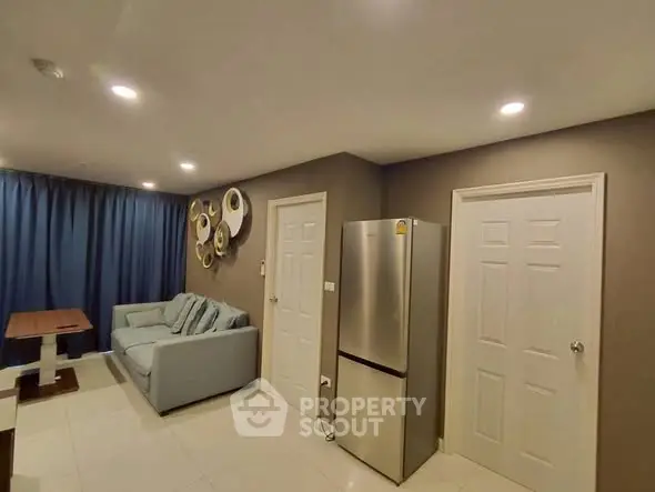 Modern living room with stylish decor and stainless steel fridge