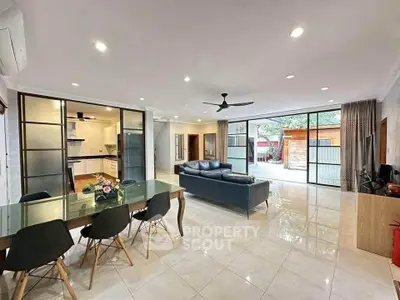 Spacious open-plan living room with modern kitchen and garden view