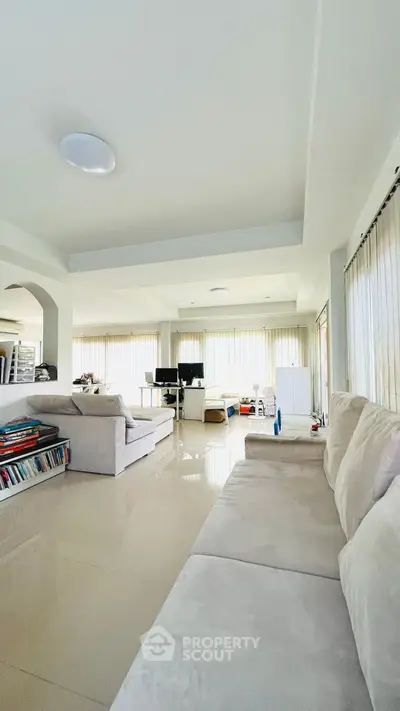 Spacious modern living room with plush sofas and natural light