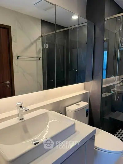 Modern bathroom with sleek fixtures and glass shower enclosure