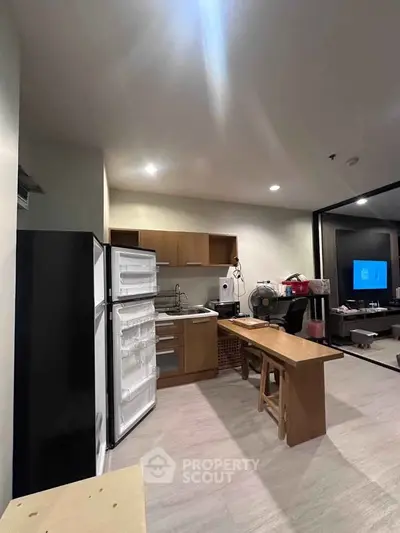 Modern kitchen with open layout and sleek appliances in a stylish apartment.