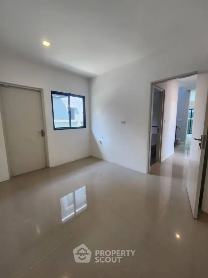 Spacious interior room with modern tile flooring and natural light