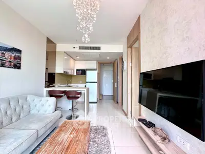 Modern living room with open kitchen, stylish decor, and natural light in a contemporary apartment.