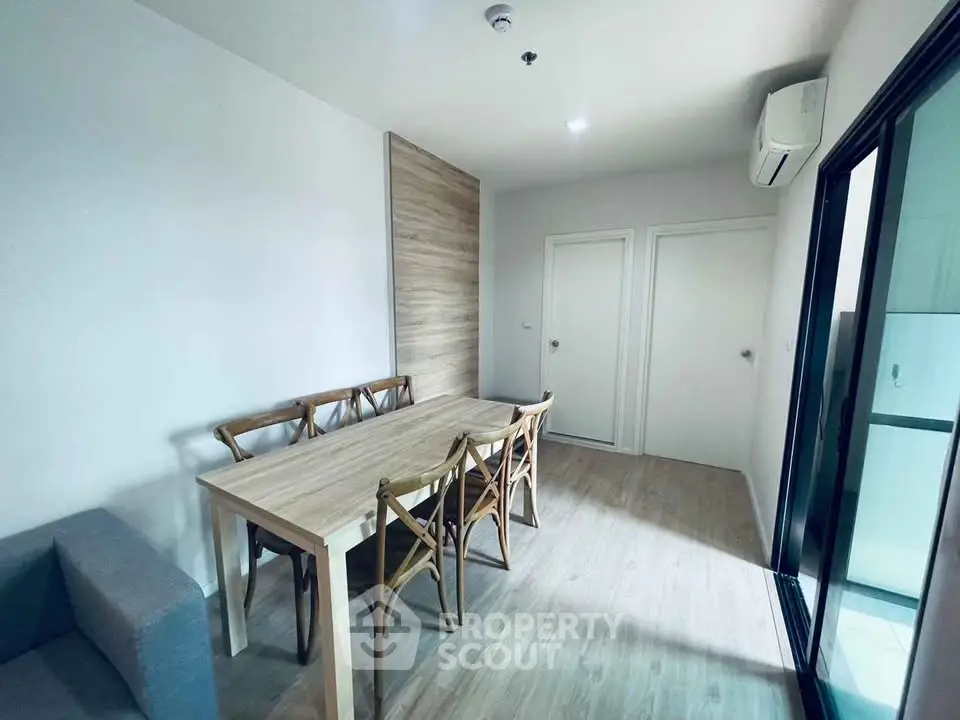 Modern dining area with wooden table and chairs in a bright apartment