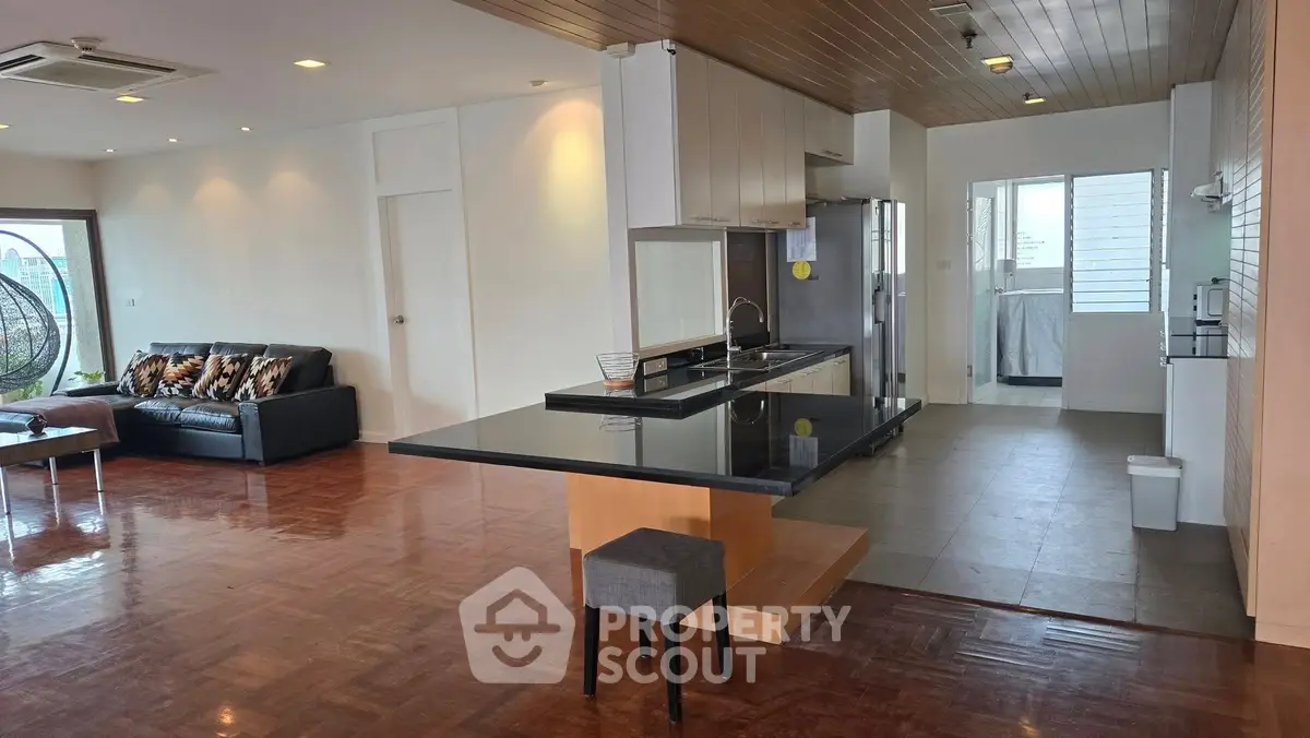 Spacious open-plan living room with modern kitchen and stylish decor