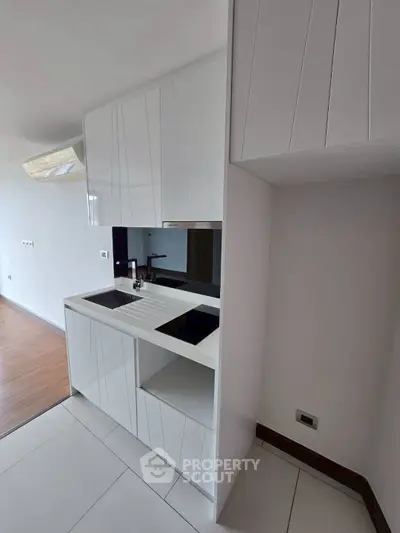Modern kitchen with sleek white cabinetry and built-in sink