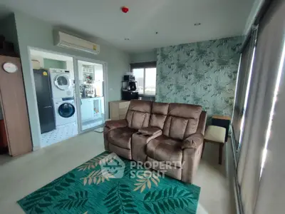 Spacious living room with modern decor and laundry area view