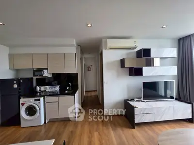 Modern open-plan living room with sleek kitchen and stylish decor