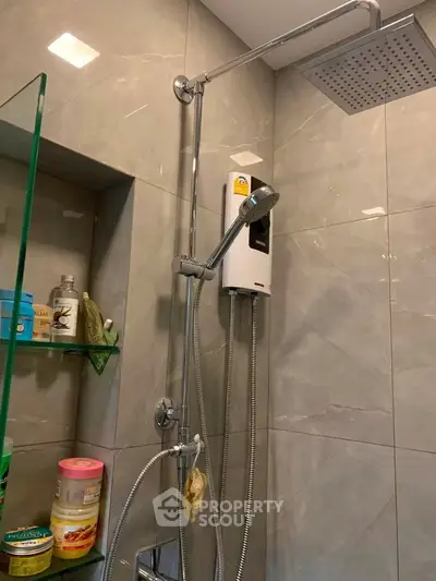 Modern bathroom with sleek shower fixtures and glass shelving