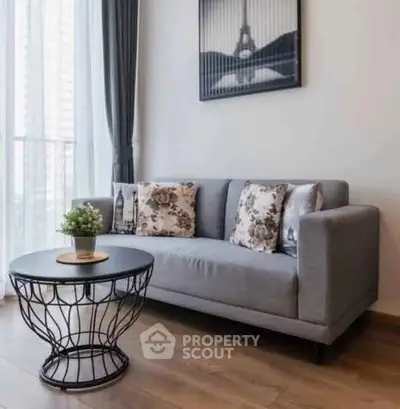 Stylish living room with modern gray sofa and chic round coffee table, perfect for urban living.