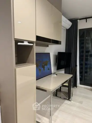 Modern study area with sleek desk, wall-mounted TV, and air conditioning in a stylish apartment.