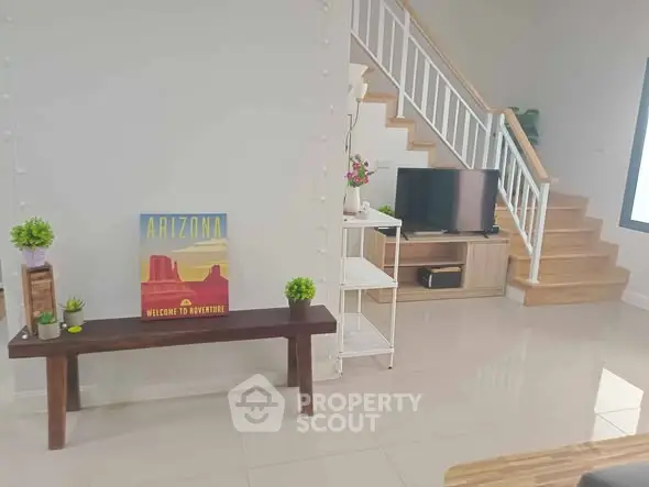Modern living room with stylish staircase and Arizona-themed decor, perfect for cozy gatherings.