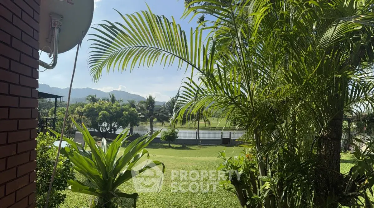 Scenic garden view with lush greenery and distant mountains, perfect for nature lovers.