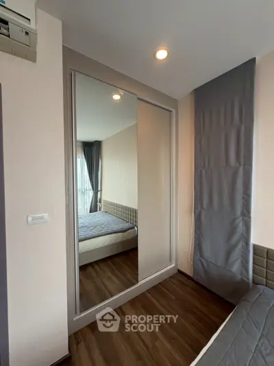 Modern bedroom with mirrored wardrobe and cozy decor