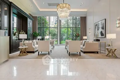 Luxurious living room with elegant chandelier and large windows overlooking greenery.