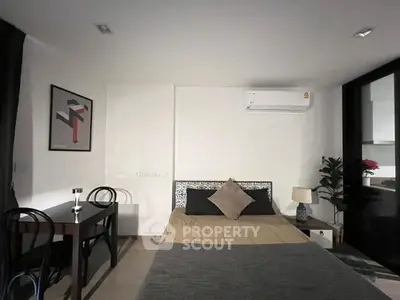 Cozy bedroom with modern decor and air conditioning, perfect for comfortable living.
