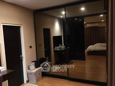 Spacious bedroom with mirrored wardrobe and cozy lighting