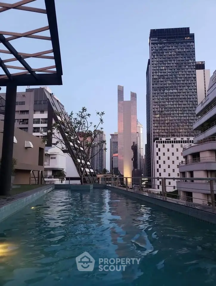 Stunning rooftop pool with city skyline view, perfect for urban living enthusiasts.