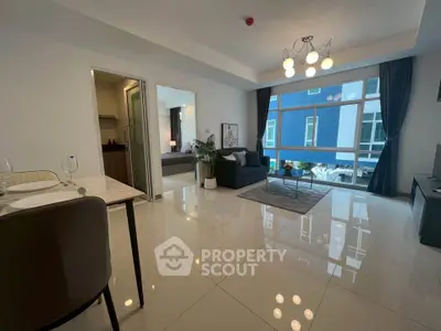 Modern open-plan living room with dining area and large windows