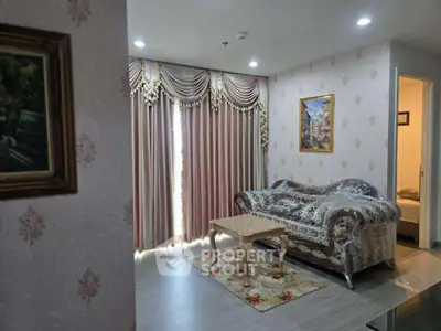 Elegant living room with ornate curtains and classic sofa set in a cozy apartment.