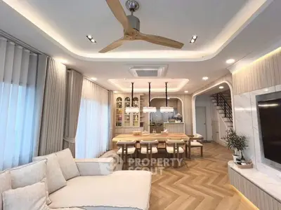 Luxurious open-plan living and dining area with modern decor and elegant lighting.