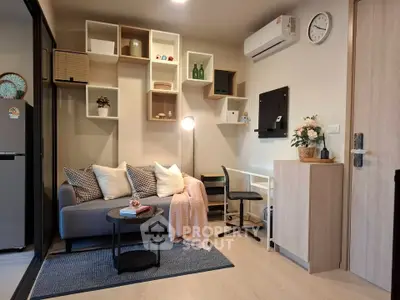 Modern living room with stylish shelving, cozy sofa, and air conditioning in a contemporary apartment.