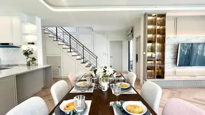 Elegant dining area with modern decor and built-in TV unit, perfect for stylish living.