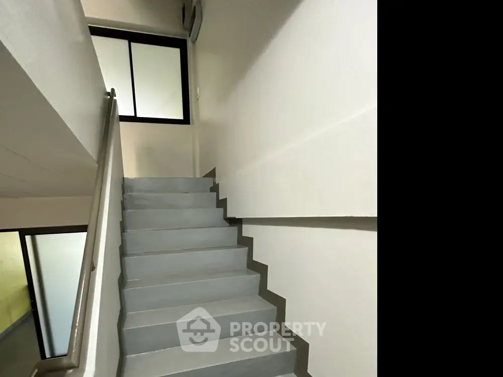Modern staircase with sleek design and minimalist aesthetic in a residential building.