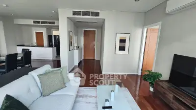 Spacious modern living room with elegant decor and open kitchen layout.