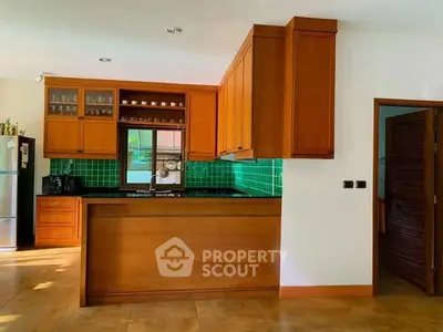 Charming kitchen with wooden cabinets and vibrant green backsplash