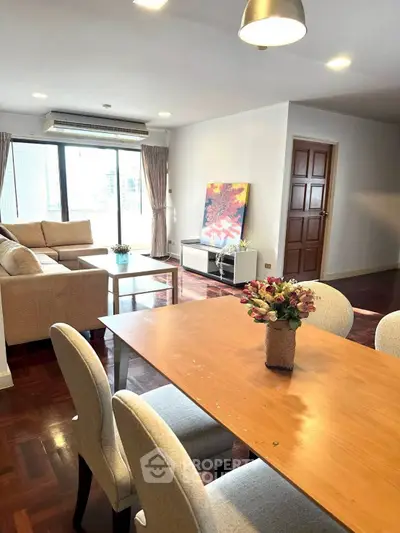 Spacious living room with modern decor and large windows offering natural light.