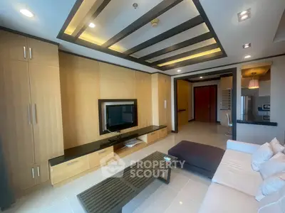 Modern living room with sleek design, built-in TV unit, and cozy seating area in a stylish apartment.