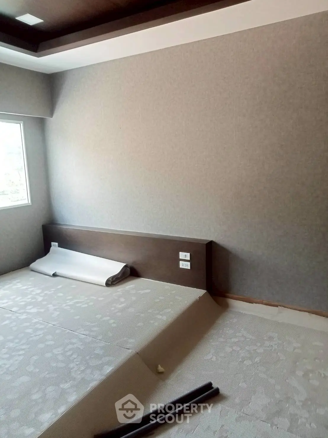 Spacious bedroom under renovation with modern design and natural light