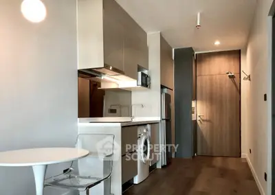 Modern apartment kitchen with sleek appliances and stylish dining area