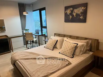 Modern bedroom with city view, stylish decor, and workspace in a high-rise apartment.